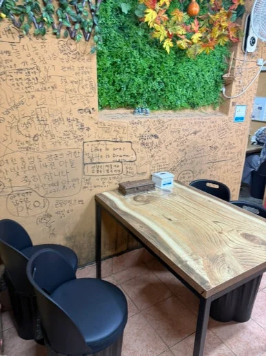 Cozy graffiti-covered corner nook inside Doraji Sikdang restaurant in Goheung Korea